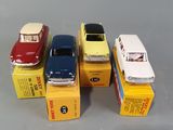 several toy cars are lined up in a row on a gray surface
