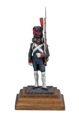 statue of a toy soldier with a rifle on a wooden base