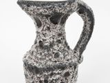 a black and white vase with a handle on a white background
