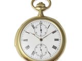 a gold pocket watch with roman numerals on it
