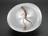 a white bowl with a piece of paper in it