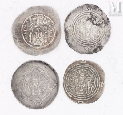 three silver coins with designs on them sitting next to each other