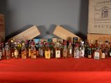 many bottles of alcohol lined up on a table