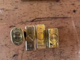 four different types of gold bars on a wooden table