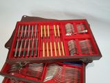 a wooden case with a set of silverware in it