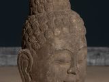 statue of a head of a person with curly hair on a table