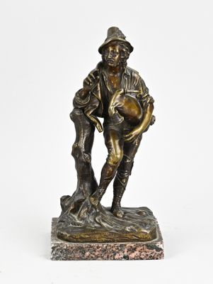 an old bronze statue of a man holding a dog