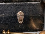 a black box with a brass handle and a key on a table