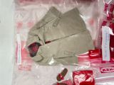 a teddy bear in a bag with other items in it