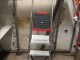 an image of a ladder in a room with a lot of tools