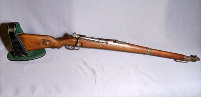 rifle on a white background with a hat on top of it