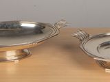 pair of silver plated dishes on wooden table with gray background
