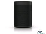 a black speaker sitting on top of a white surface