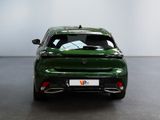 the rear view of a green car in a showroom
