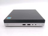the back of a small black computer sitting on top of a white surface