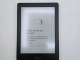 an image of a kindle sitting on top of a table next to a white wall