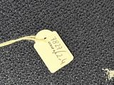 a tag on a piece of luggage that is sitting on the floor