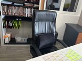 a desk with a computer and a chair in a room
