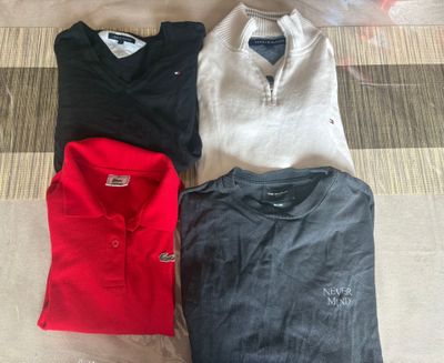 four polo shirts laid out on the floor next to each other