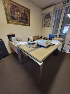 a desk with a laptop and a bag on it