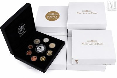 four different types of coins in a white box on a white background