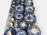 a tray of blue and white china on a white table