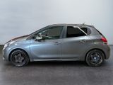 the silver car is parked in a large room with a white wall