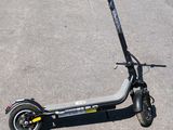 a scooter that is sitting on the pavement