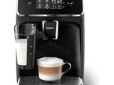 a black coffee machine with a glass of milk next to it