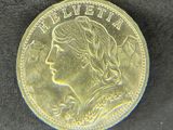 l'image d'une pièce d'or sur laquelle figure le visage d'une femme