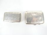pair of antique silver cigarette cases with engraved designs on them