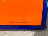 an orange and blue sign sitting on top of a cement floor
