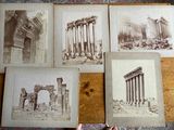 several old photographs of ruins and columns on a wooden floor