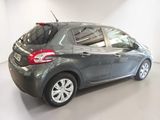 the back end of a grey car parked in a white room
