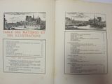 an open book with a picture of a city on it