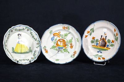 trois assiettes ornées de motifs différents, posées sur une surface noire