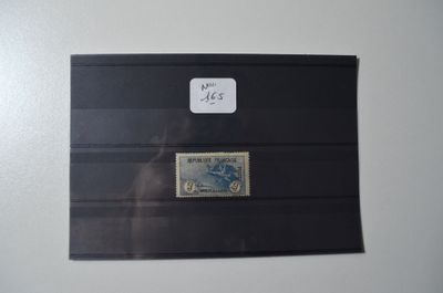 an envelope with a stamp on it sitting on top of a table