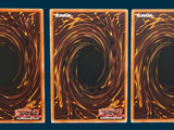 three cards that have a picture of a spiral design on them