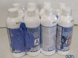 several bottles of cleaning products are lined up on a counter