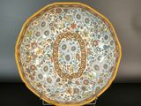 a plate with a floral design on it on a table