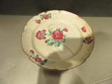 a white plate with pink flowers on it on a table