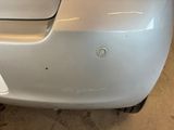 a close up of a car ' s bumper with a hole in it