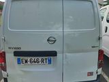a white van parked in a parking lot next to a white van