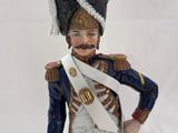 figurine of a man in a military uniform holding a sword