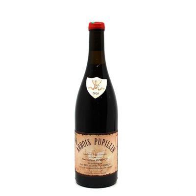an old bottle of wine sitting on top of a white surface