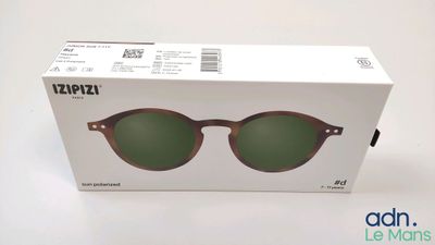 the box of a pair of sunglasses is open on a white surface