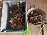 a bucket full of screws and nails next to a bucket of screws