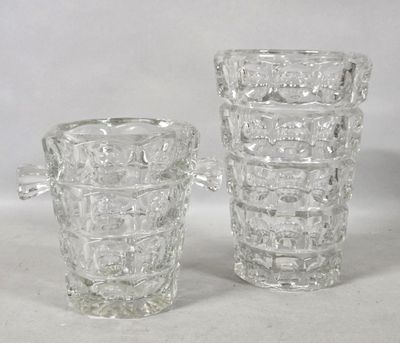 two clear glass vases sitting next to each other on a white surface