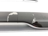 a close up of a car ' s bumper with a denting on it