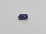 a close up of a blue stone on a white surface